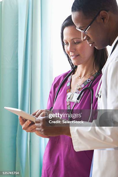 doctors going over data - physician assistant stock pictures, royalty-free photos & images