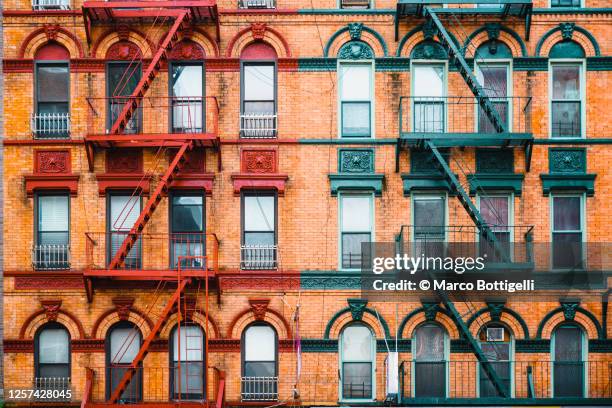fire escape stairs on typical buildings, new york city - the soho house stock pictures, royalty-free photos & images