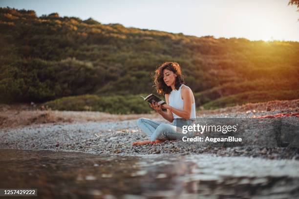 frau lesen buch und entspannen am strand - beach book reading stock-fotos und bilder