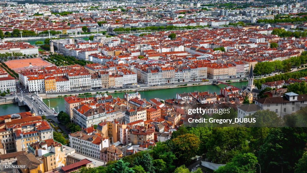 Aerial view of Lyon French cityscape with Saone riverbank in summer with historic monuments along quayside
