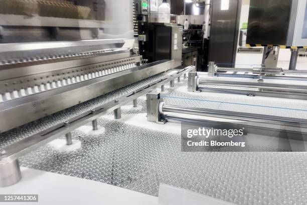 Glass vials move along a production line conveyor at the GSK Plc research and development center in Wavre, Belgium, on Thursday, May 11, 2023. The...