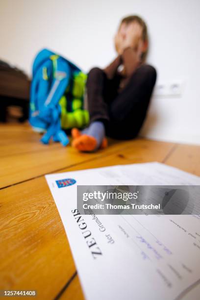 Symbolic photo on the subject of testimonials in elementary school. A boy poses with a certificate on May 19, 2023 in Berlin, Germany.