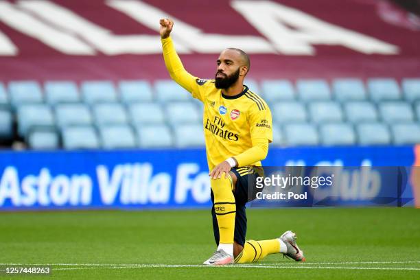 Alexandre Lacazette of Arsenal takes a knee in support of the Black Lives Matter movement prior to during the Premier League match between Aston...
