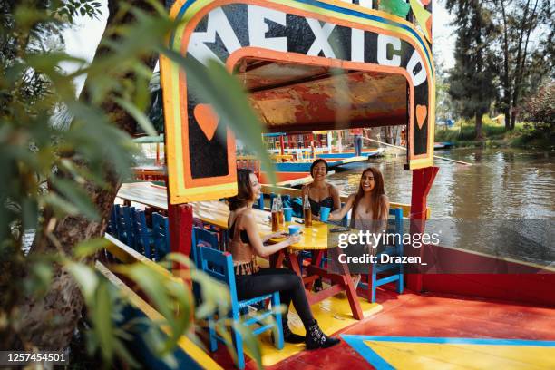 latin travelers on city break enjoying boat ride - cidade do méxico imagens e fotografias de stock