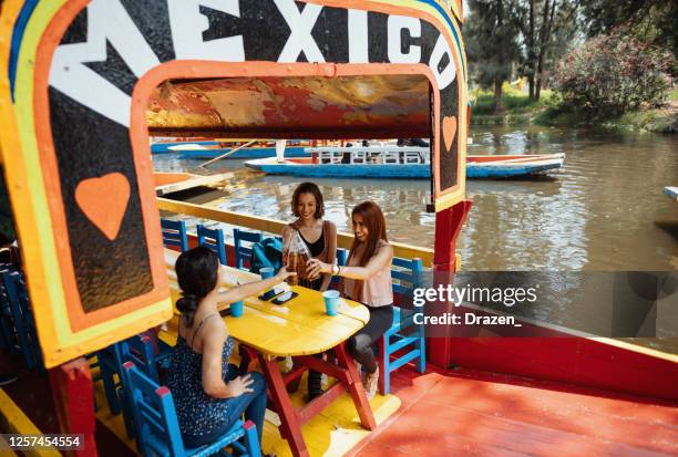 latin travelers on city break enjoying boat ride - mexico city tourist stock pictures, royalty-free photos & images