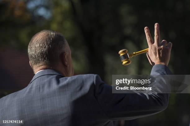 An auctioneer gestures with a gavel during an auction of a property in Sydney, Australia, on May 20, 2023. In Australia, it's never been harder for...