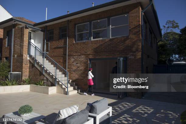 Woman inspects a room before an auction of a property in Sydney, Australia, on May 20, 2023. In Australia, it's never been harder for people to get...