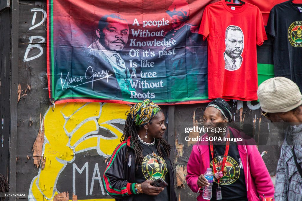 People are seen in Peckham Square during a demonstration to...