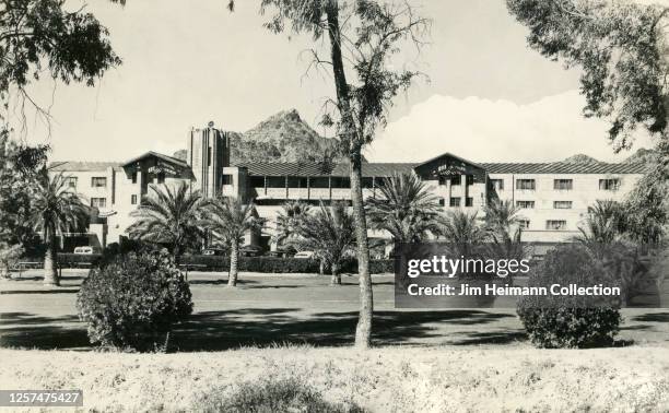 The exterior of the Arizona Biltmore in Phoenix by architect Albert Chase McArthur is surrounded by an expansive lawn and freshly planted palm trees,...