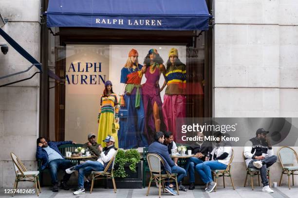 Customers gather together at the outside cafe tables at the Ralph Lauren shop on Bond Street on 22nd May 2023 in London, United Kingdom. Bond Street...