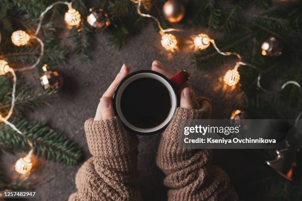 a female hands holding cup of coffee latte art on wood table. above view and vintage effect. - coffee cup top view stockfoto's en -beelden
