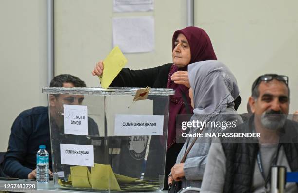 Woman casts her ballot at a polling station set up in the Grugahalle hall in Essen, western Germany, on May 23 ahead of Turkey's first run-off...