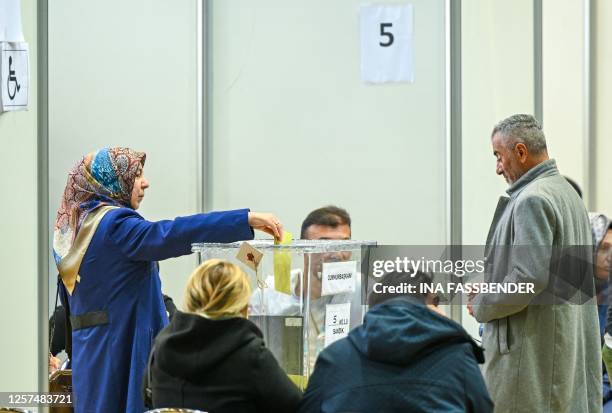 Woman casts her ballot at a polling station set up in the Grugahalle hall in Essen, western Germany, on May 23 ahead of Turkey's first run-off...