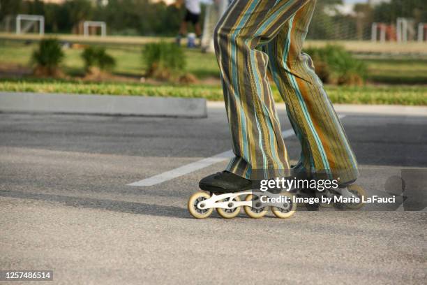 inline skating in the park - flared trousers stock pictures, royalty-free photos & images