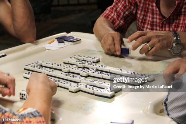 adults playing dominoes - cuban culture stock pictures, royalty-free photos & images