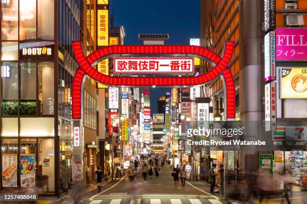 entrance to kabukicho central road at sunset - godzilla named work stock pictures, royalty-free photos & images