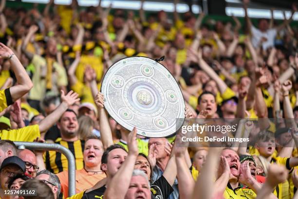 Fans with the championship trophy during the Bundesliga match between FC Augsburg and Borussia Dortmund at WWK-Arena on May 21, 2023 in Augsburg,...