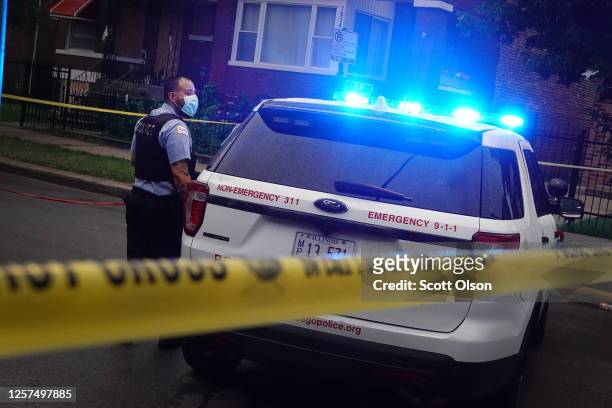 Police investigate the scene of a shooting in the Auburn Gresham neighborhood on July 21, 2020 in Chicago, Illinois. At least 14 people were...