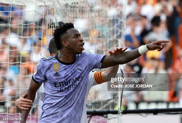 Real Madrid's Brazilian forward Vinicius Junior reacts to being insulted pointing at the stands during the Spanish league football match between...