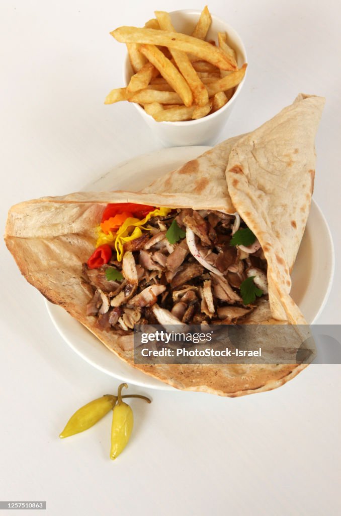 Lamb and turkey shawarma in a Lafa (flat Iraqi pita) with french fries