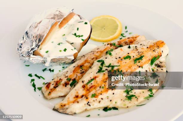 baked gilt head bream with baked potato in foil - sparus aurata stock pictures, royalty-free photos & images