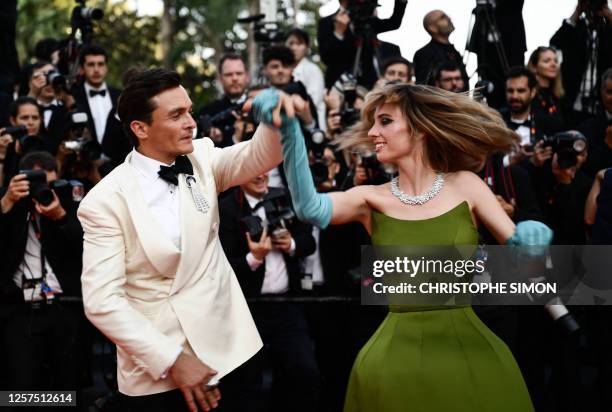 British actor Rupert Friend and US actress Maya Hawke dance as they arrive for the screening of the film "Asteroid City" during the 76th edition of...