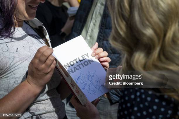 Rachel Notley, Alberta New Democratic Party candidate for Alberta premier, right, signs a book at an advance polling station in Calgary, Alberta,...