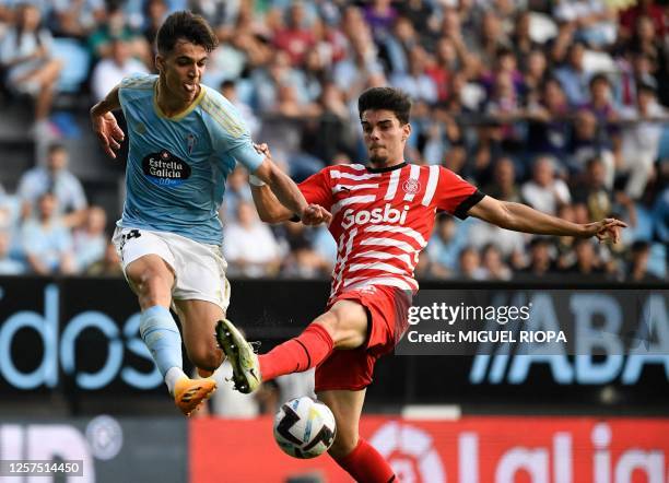 Celta Vigo's Spanish midfielder Gabriel Veiga fights for the ball with Girona's Spanish defender Miguel Gutierrez during the Spanish league football...