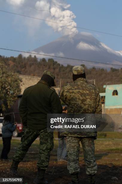 Mexican soldiers observe the Popocatepetl volcano from the village of Santiago Xalitzintla in Puebla state, Mexico on May 23, 2023. Mexican...