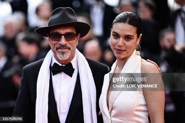 French-Afghan writer and film director Atiq Rahimi and French actress Alice Rahimi arrive for the screening of the film "Asteroid City" during the...
