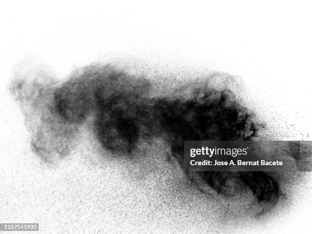 full frame of the textures formed  by the water jets to pressure with drops floating in the air of black color on a white background - spray paint isolated stock pictures, royalty-free photos & images