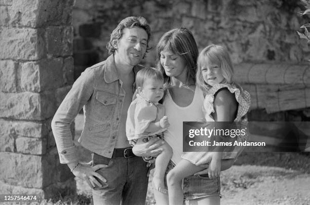 French singer and songwriter Serge Gainsbourg with British singer and actress Jane Birkin, who holds in her arms her daughters, Charlotte and Kate...