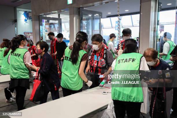 Consadole Sapporo supporters use mobile phones and QR codes as tickets to avoid contacts on arrival at the stadium prior to the J.League Meiji Yasuda...
