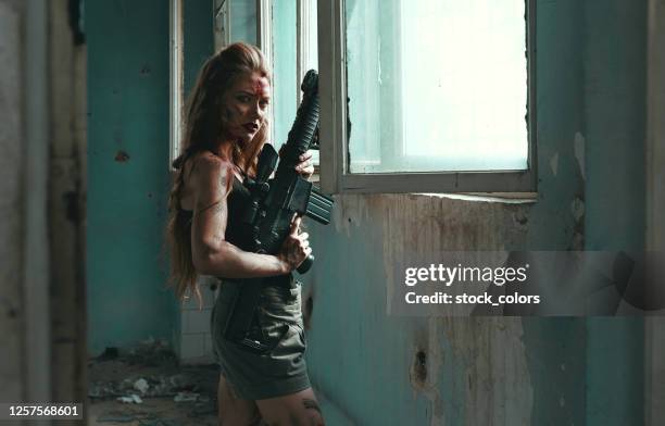 dangerous blond holding huge rifle - pointing at camera stock pictures, royalty-free photos & images