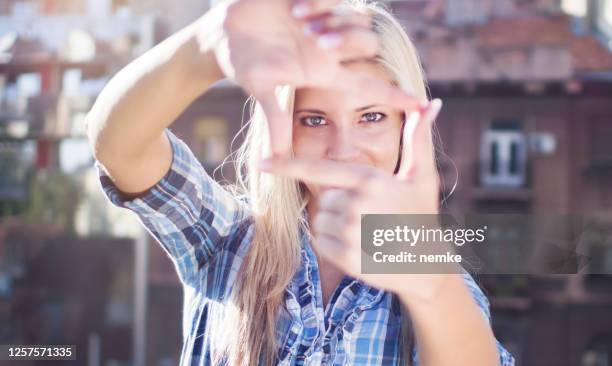 female film director looking trough hands frame - vision films stock pictures, royalty-free photos & images