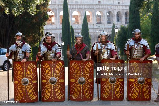 1st and 2nd century BC legionaries of the most famous Roman reenactment group, the Gruppo Storico Romano, pose in front of Coliseum during the event...