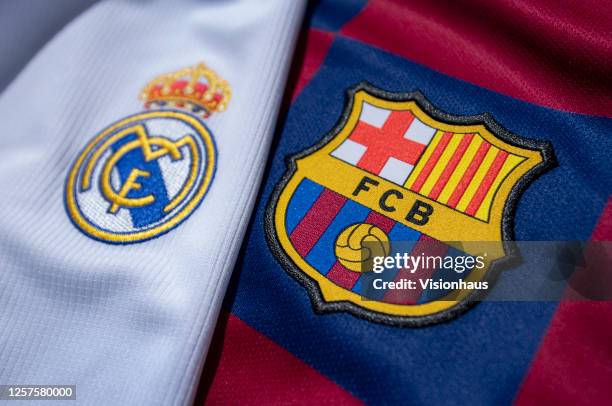 The FC Barcelona and Real Madrid club crests on the first team home shirts on July 22, 2020 in Manchester, United Kingdom.