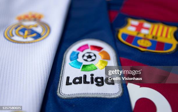 The La Liga logo with the FC Barcelona and Real Madrid club crests on the first team home shirts on July 22, 2020 in Manchester, United Kingdom.