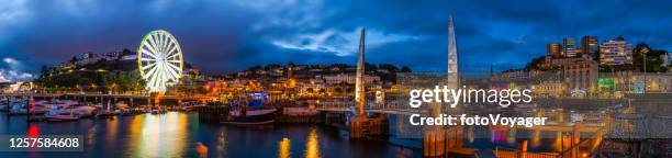 torquay harbour promenade waterfront illuminated at dusk panorama dorset uk - torquay stock pictures, royalty-free photos & images