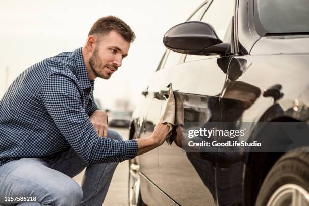 junger mann poliert sein auto - polish car stock-fotos und bilder