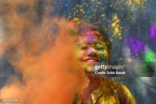 portrait of indian woman with colored face during holi,india. - ホーリー祭 ストックフォトと画像