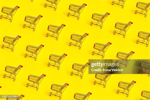 shopping trolley pattern on yellow background. - chariot wheel photos et images de collection