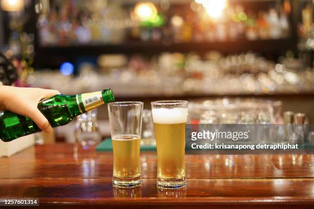 young women drink beer at the bar.,substance abuse - tablet alcohol stock pictures, royalty-free photos & images