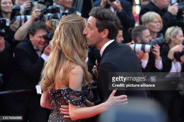 May 2023, France, Cannes: Adrien Brody and girlfriend Georgina Chapman arrive on the red carpet before the premiere of the film "Asteroid City" at...