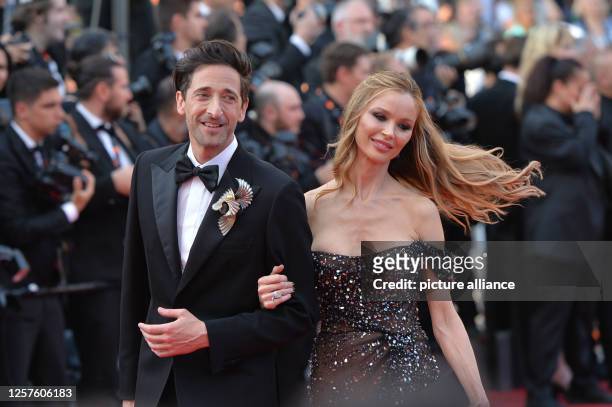 May 2023, France, Cannes: Adrien Brody and girlfriend Georgina Chapman arrive on the red carpet before the premiere of the film "Asteroid City" at...