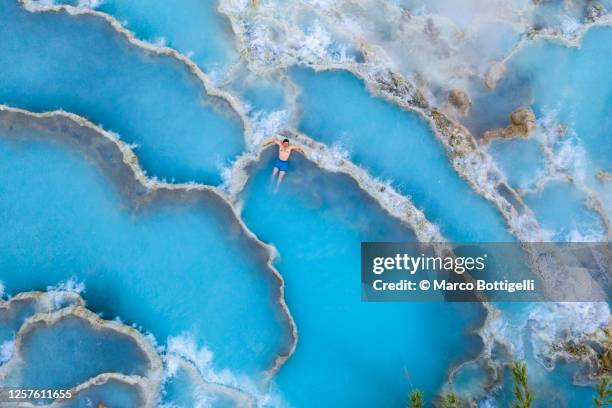 man relaxing in natural hot springs, tuscany, italy - hot spring stock pictures, royalty-free photos & images