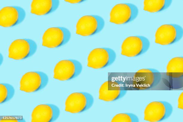 tropical pattern of lemon citrus on blue color background. - traditional lemonade stock pictures, royalty-free photos & images