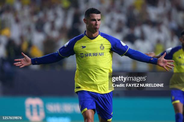 Nassr's Portuguese forward Cristiano Ronaldo reacts after scoring during the Saudi Pro League football match between Al-Nassr and Al-Shabab at the...