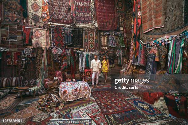 young tourists enjoying at traditional carpet shop in cappadocia, turkey - capadócia imagens e fotografias de stock