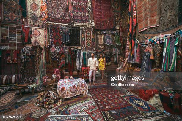 young tourists enjoying at traditional carpet shop in cappadocia, turkey - feira árabe ao ar livre imagens e fotografias de stock